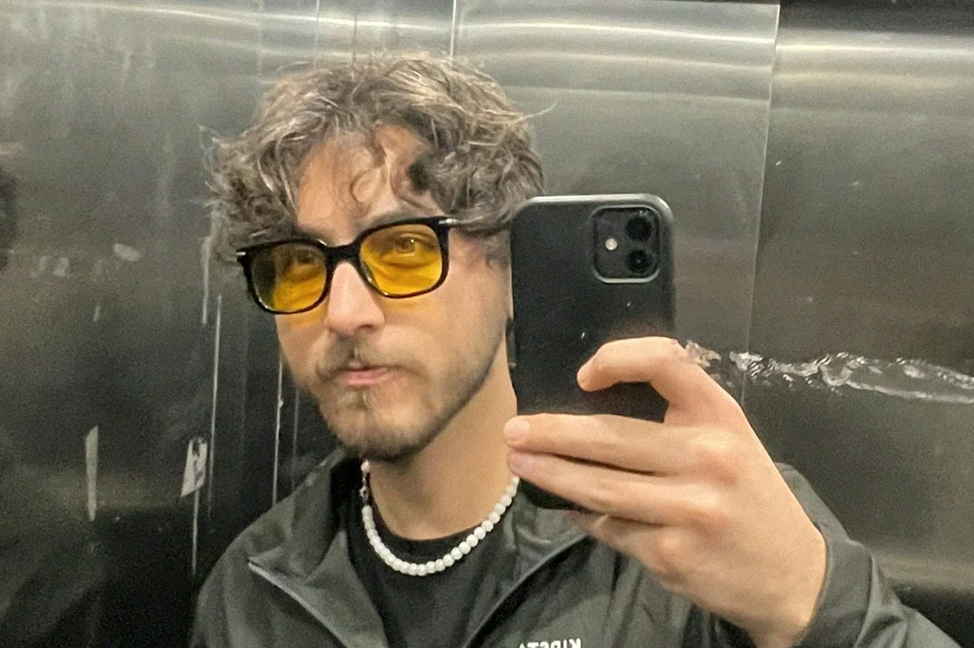 Mirror selfie in yellow glasses, frame 1
